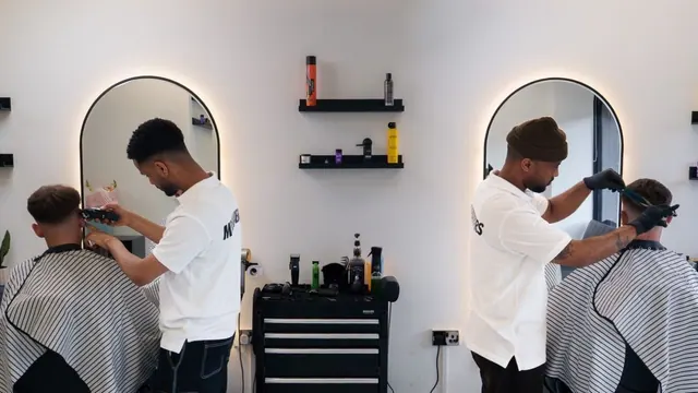 Barbers at work at the arched mirrors